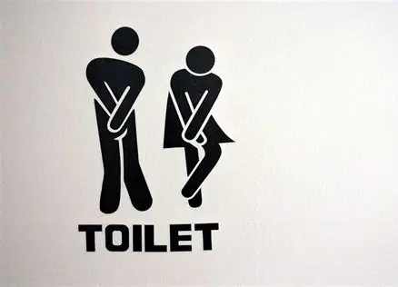 Bathroom sign featuring a man and woman standing side by side, indicating facilities for both genders.
